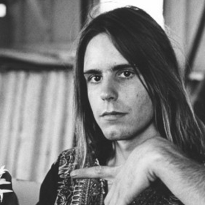 photograph of a young Bob Weir, long-haired and looking directly at the camera